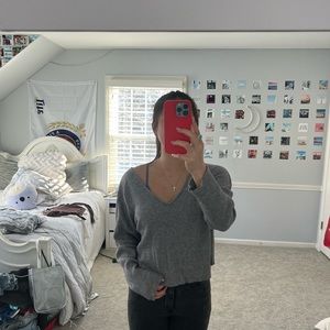 gray v-neck long sleeve sweater. no tears, rips or lacerations